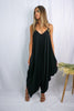 Blonde girl modeling a black boxy hi lo jumpsuit for Scarlette The Label, an online fashion boutique for women. Black jumpsuit has pockets and is lightweight and flowy. 