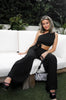 Woven and pleated one shoulder pant set in black with flare pants and side pockets. Scarlette The Label, an online fashion boutique for women.