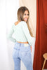 Load image into Gallery viewer, Blonde girl models off the shoulder knit crop top in baby blue for Scarlette The Label, an online fashion boutique for women. Paired with light wash blue denim ripped jeans.