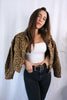 Load image into Gallery viewer, Brunette girl models a buttoned leopard jacket for Scarlette The Label, an online fashion boutique for women. Paired with white ribbed spaghetti strap tank top in white and dark denim jeans.