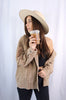 Load image into Gallery viewer, Brunette girl models buttoned corduroy jacket in the color tan for Scarlette The Label, an online fashion boutique for women. The corduroy jacket is an oversized street style jacket. Paired with a black crop top, dark denim jeans, and a wide-brimmed rancher hat.