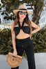 Load image into Gallery viewer, Adjustable, versatile Vacation Wrap Top in Black at Scarlette The Label, an online fashion boutique for women. Top can be worn multiple ways. Paired with black flare bell bottom pants.