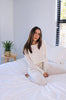 Load image into Gallery viewer, Long sleeve and pants linen loungewear set in color: natural (ivory) for Scarlette The Label, an online fashion boutique for women. Loungewear jogger pants have draw strings and long sleeve shirt is buttoned. 