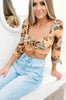 Load image into Gallery viewer, Blonde girl models a quarter sleeve floral crop top in the color Squash Flower for Scarlette The Label, an online fashion boutique for women. Paired with light wash denim boyfriend jeans.