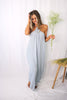 Blonde girl models a hi lo flowy, boxy jumpsuit in the color Gray for Scarlette The Label, an online fashion boutique for women.
