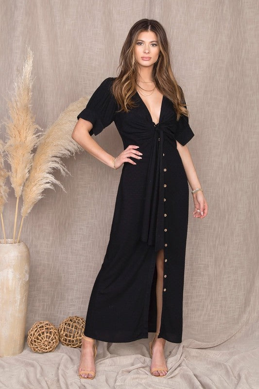 Short Puff Sleeve Buttoned Maxi Dress in Black from Scarlette The Label, an online fashion boutique for women. Paired with black purse, black sunglasses and leopard print heels boots.