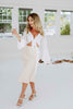 Load image into Gallery viewer, Blonde girl models ivory satin skirt and white flared sleeve tie top for Scarlette The Label, an online fashion boutique for women. The top is a white flared sleeve tie top and the skirt is a mid-length ivory satin skirt with a stretchy waist band. Paired with white heels.