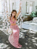 Load image into Gallery viewer, Blonde girl models magenta vacation maxi dress for Scarlette The Label, and online fashion boutique for women. The magenta vacation maxi dress is long, flowy, and has floral details.