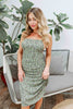 Load image into Gallery viewer, Blonde girl models a green crossback mini dress for Scarlette The Label, an online fashion boutique for women. The mini dress is a scrunched mini dress with floral details, spaghetti straps, and a plunging crossback design in the back.