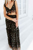 Load image into Gallery viewer, Blonde girl models black frilled maxi skirt set in black for Scarlette The Label, an online fashion boutique for women. The matching skirt set includes a black tie crop top and  black, long, flowy maxi skirt. Floral details.